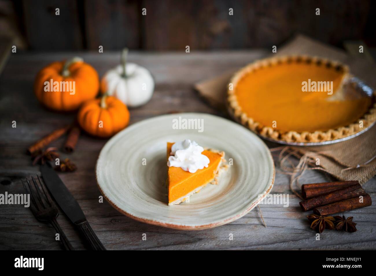 Pumpkin pie on rustic wooden surface Stock Photo