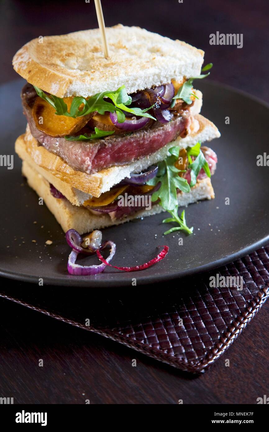 Beef steak, onion and ricotta sandwich Stock Photo