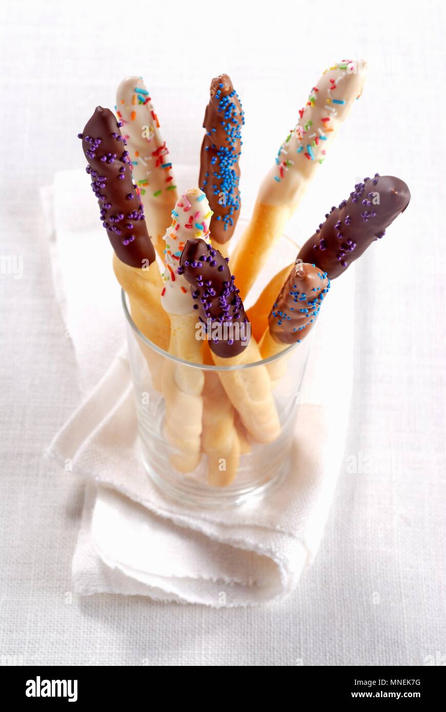 Chocolate glazed breadsticks with sprinkles Stock Photo Alamy