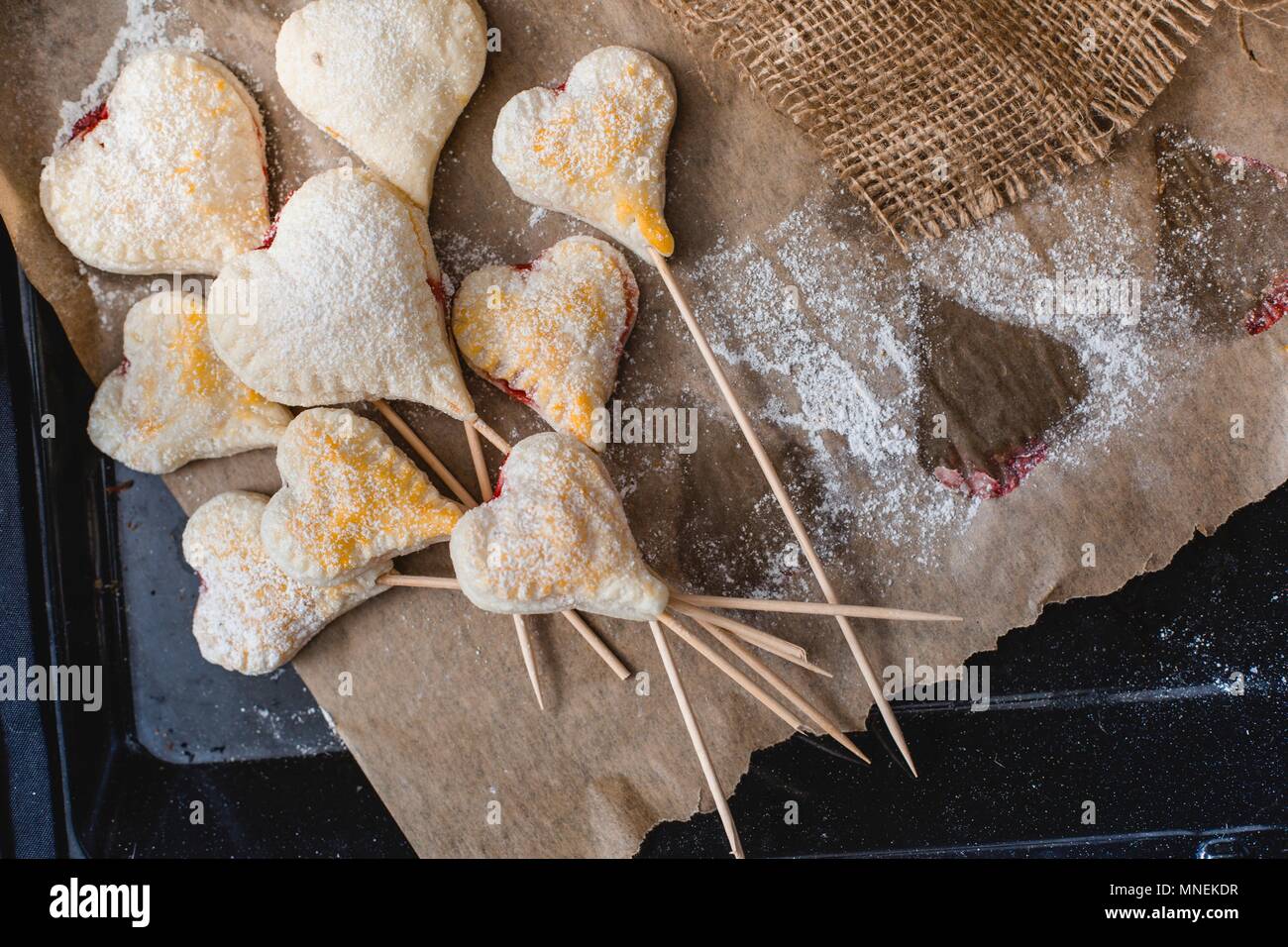 Heart-shaped jam-filled biscuits on sticks Stock Photo
