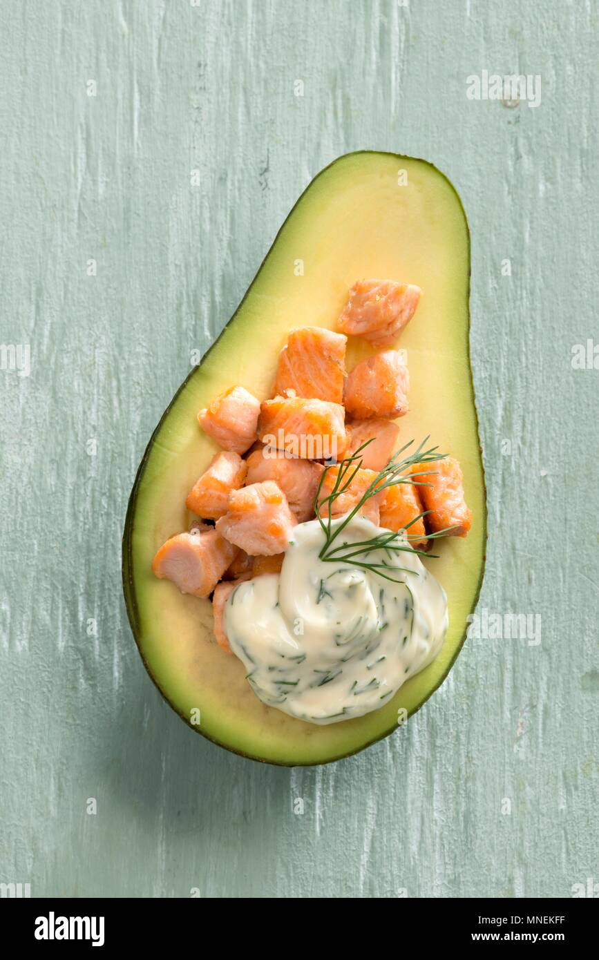 Avocado filled with salmon and dill cream Stock Photo
