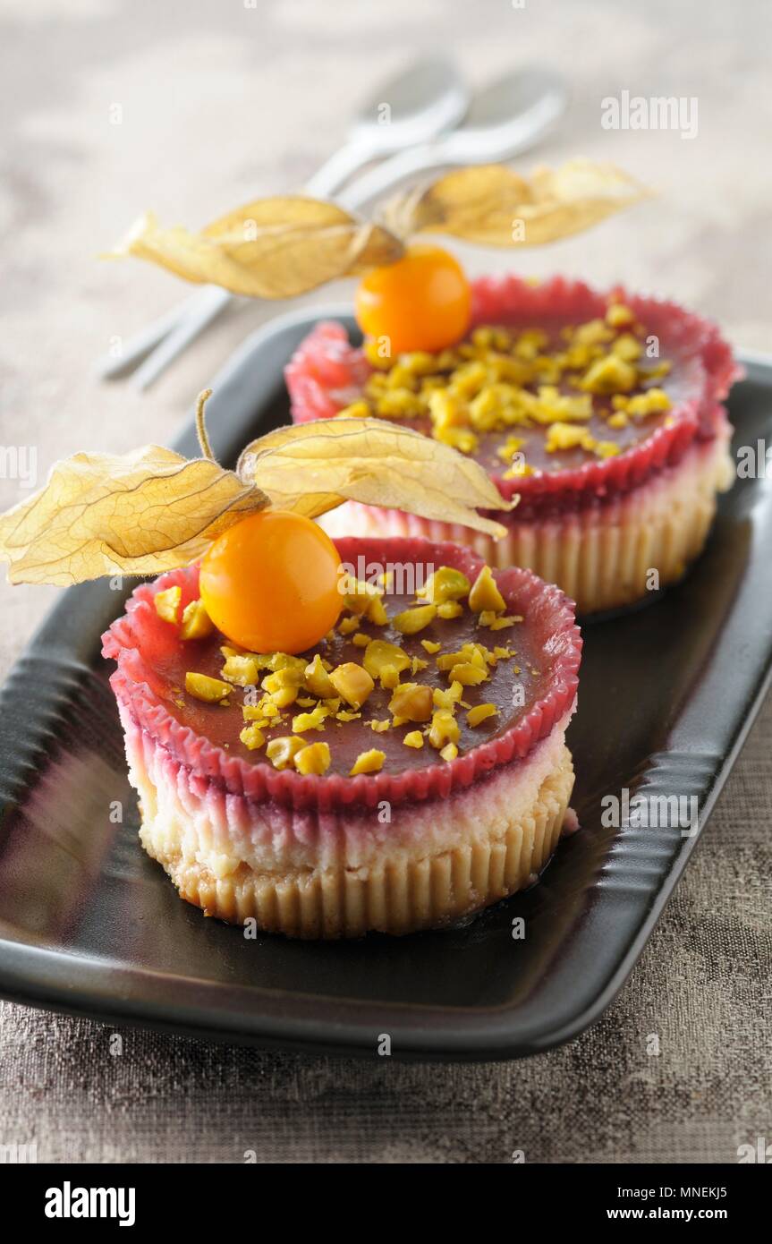 Mini Cheesecakes With Red Fruits Physalis And Pistachios Stock Photo Alamy