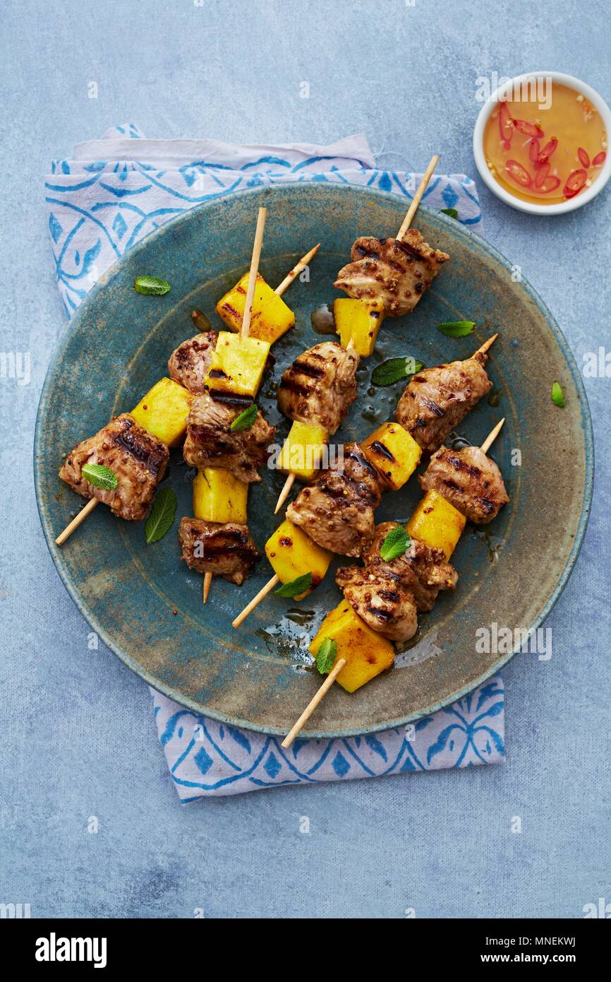 Grilled pork and mango kebabs with chilli sauce Stock Photo