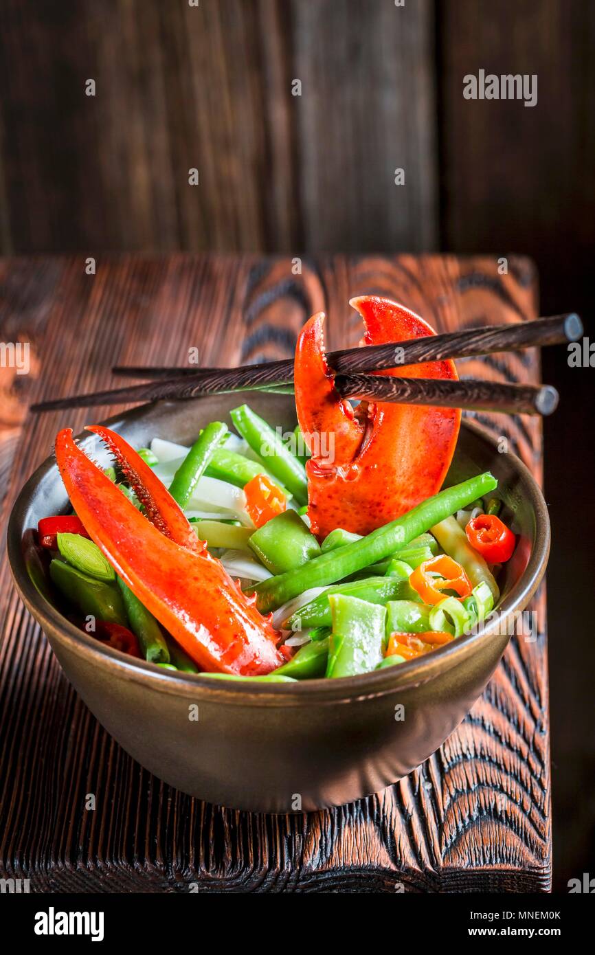 Noodles with vegetables, lobster and chopsticks (Asia) Stock Photo
