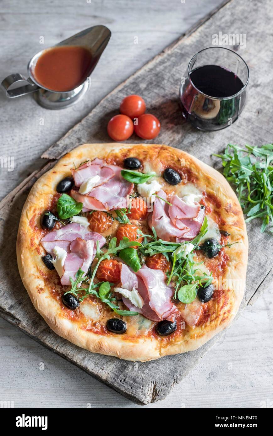 Ham and cheese pizza served on the wooden board Stock Photo