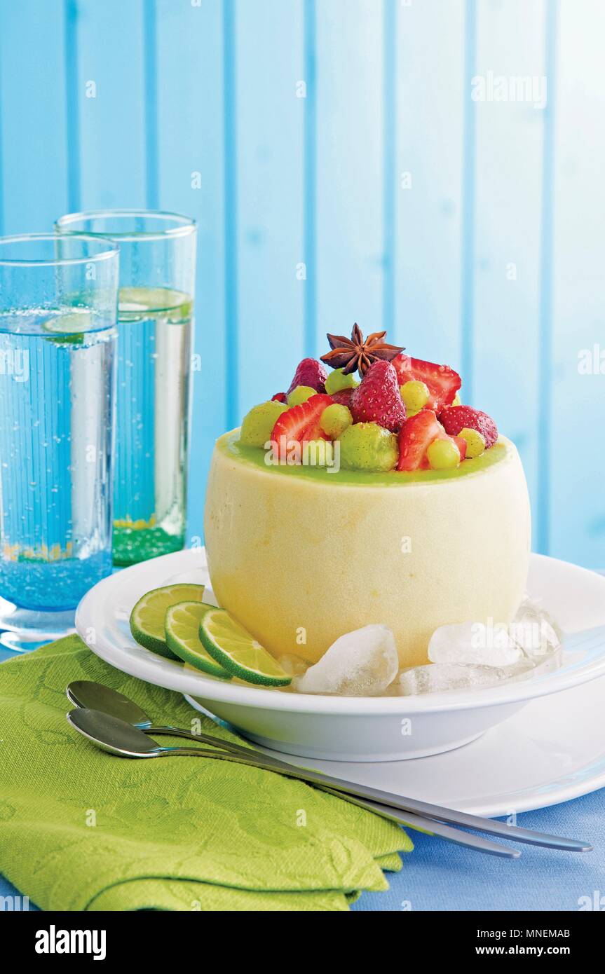 Strawberry & melon salad with ginger in an hollowed out melon Stock