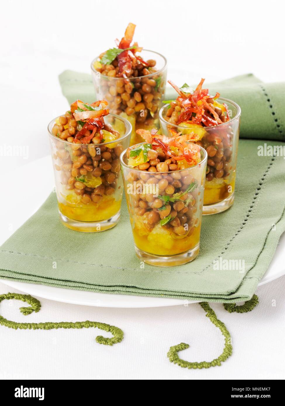 Lentil salad with oranges and strips of ham served in glasses Stock Photo