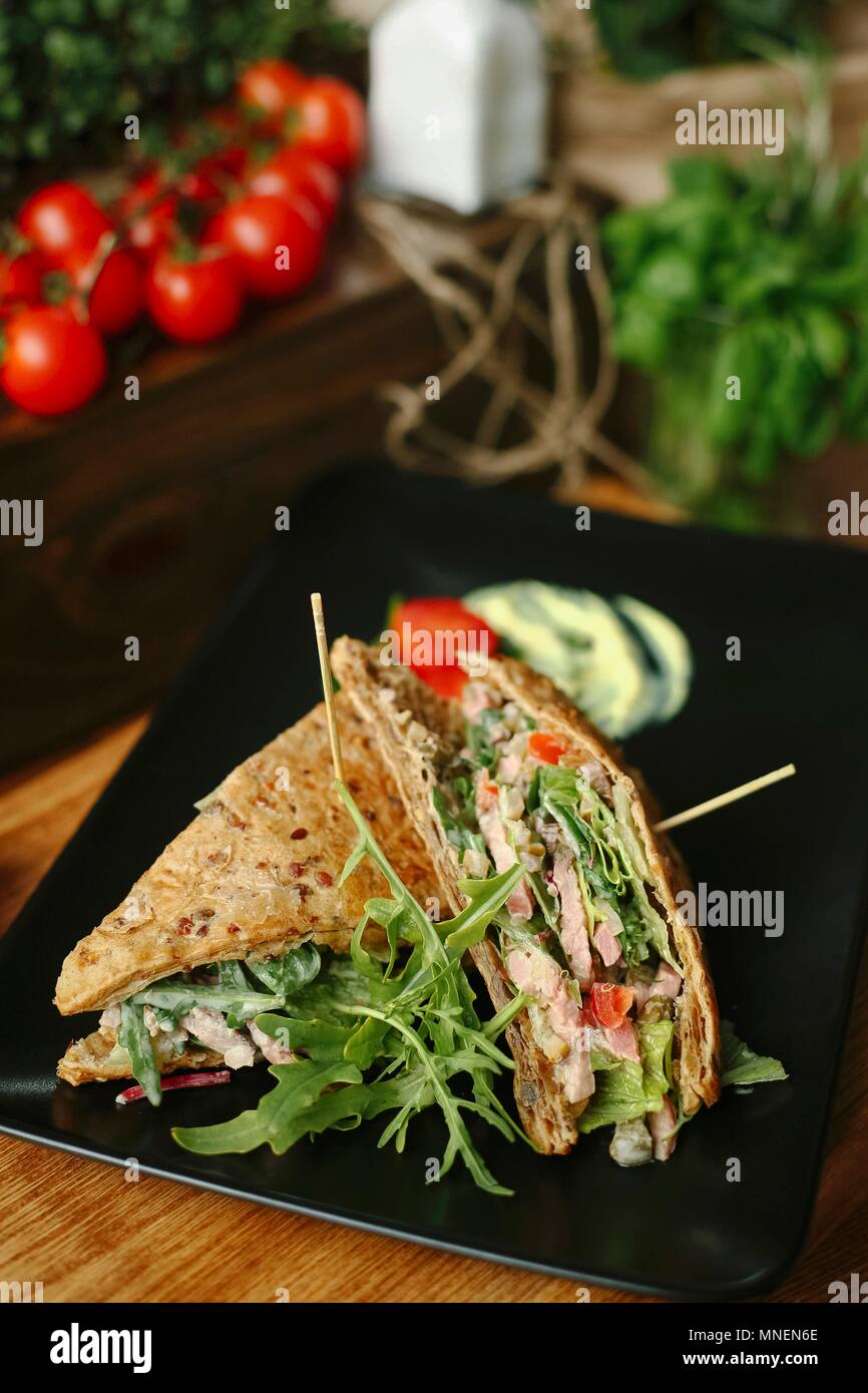 A turkey sandwich with rocket and tomato Stock Photo