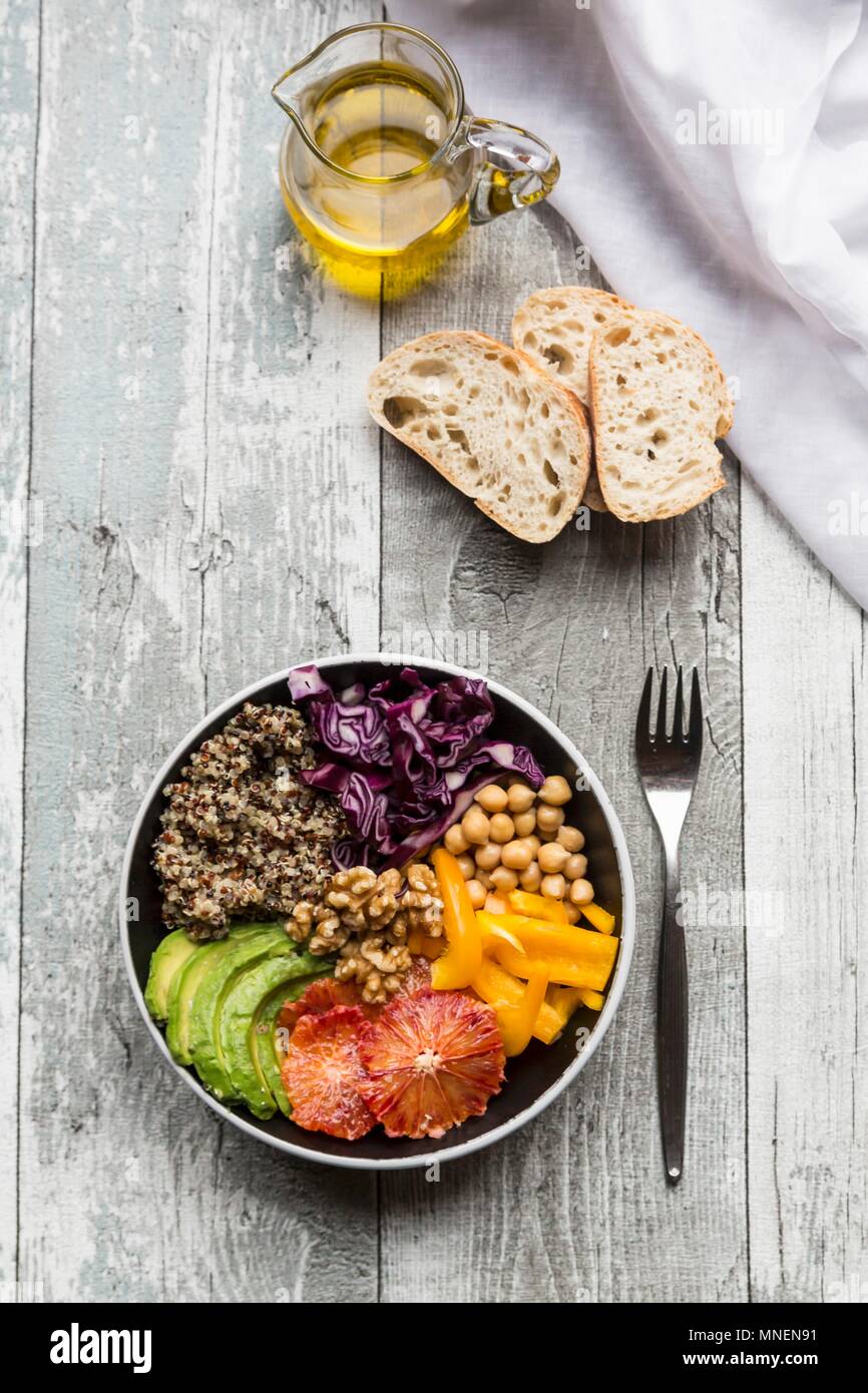 A veggie bowl with quinoa, chickpeas, avocado, peppers, red cabbage and blood oranges Stock Photo
