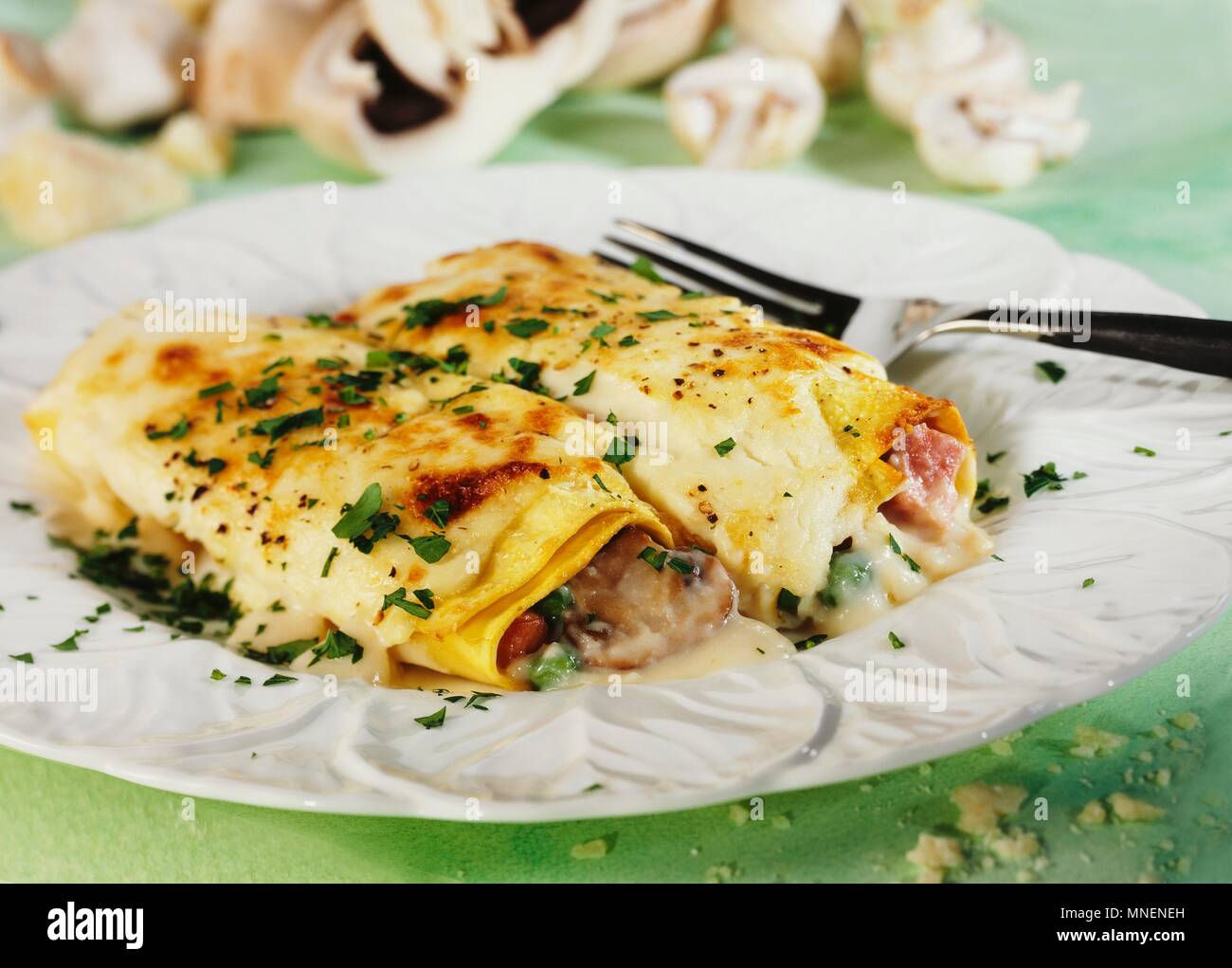 Pancakes filled with mushrooms, ham and cheese Stock Photo