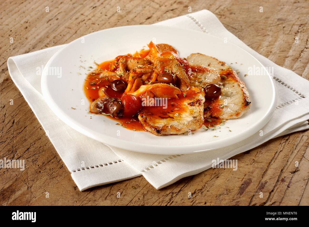 Pork escalopes with olive & tomato sauce Stock Photo