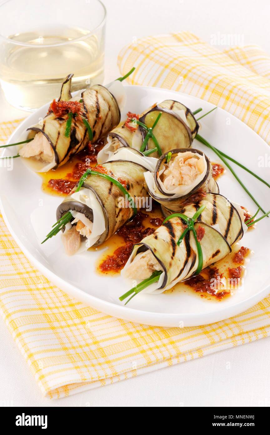 Aubergine rolls filled with fish in a tomato oil Stock Photo