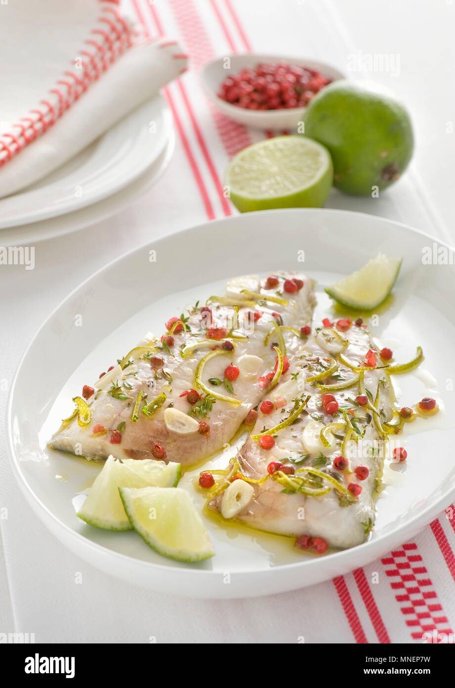 Mackerel fillets with pink pepper, limes and garlic Stock Photo
