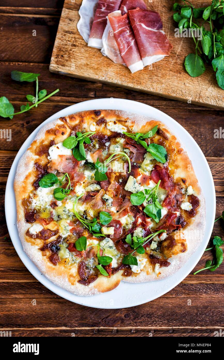 Homemade pizza with blue cheese, pancetta, onion chutney and lamb's