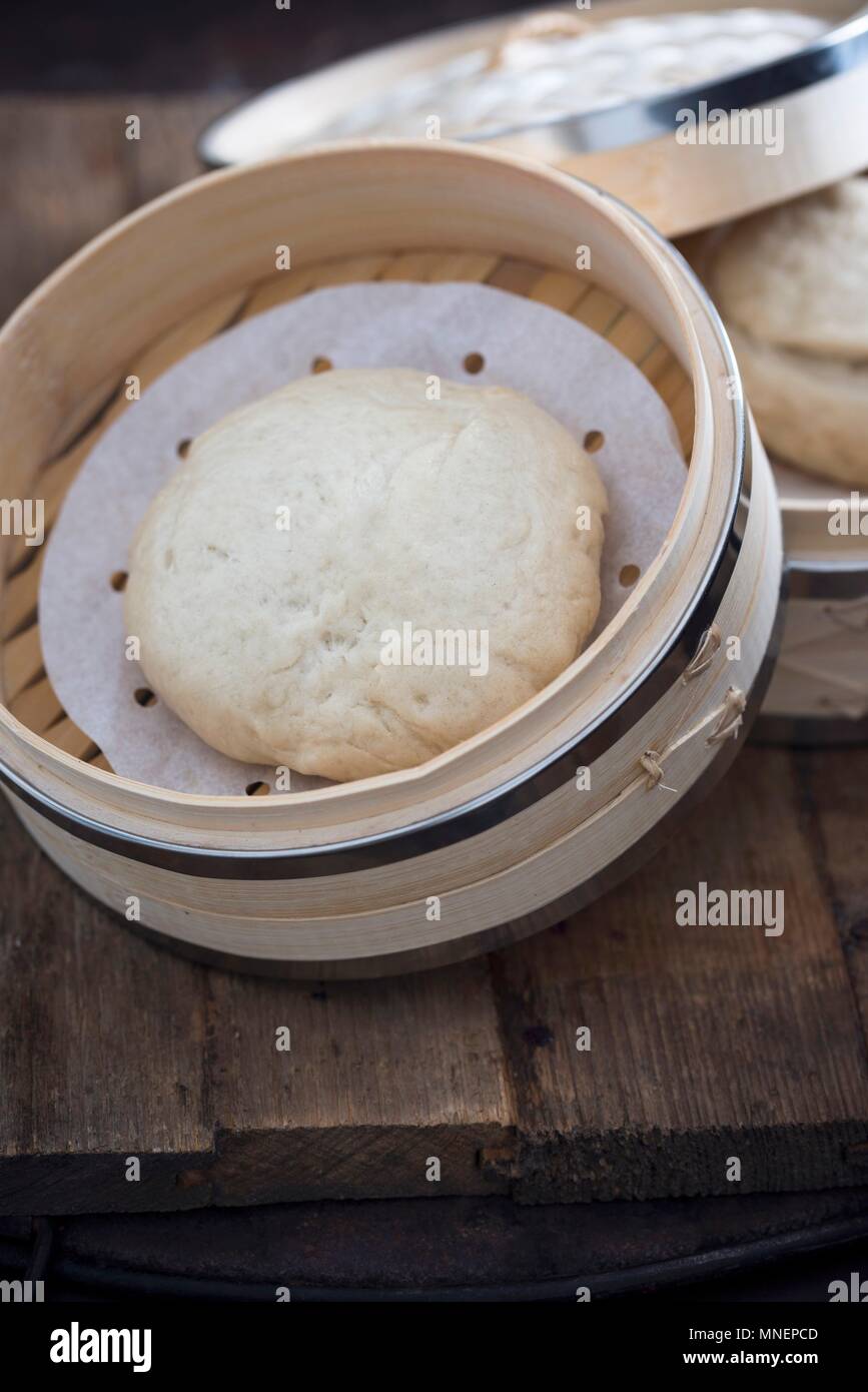 A bao bun in a bamboo steamer Stock Photo Alamy