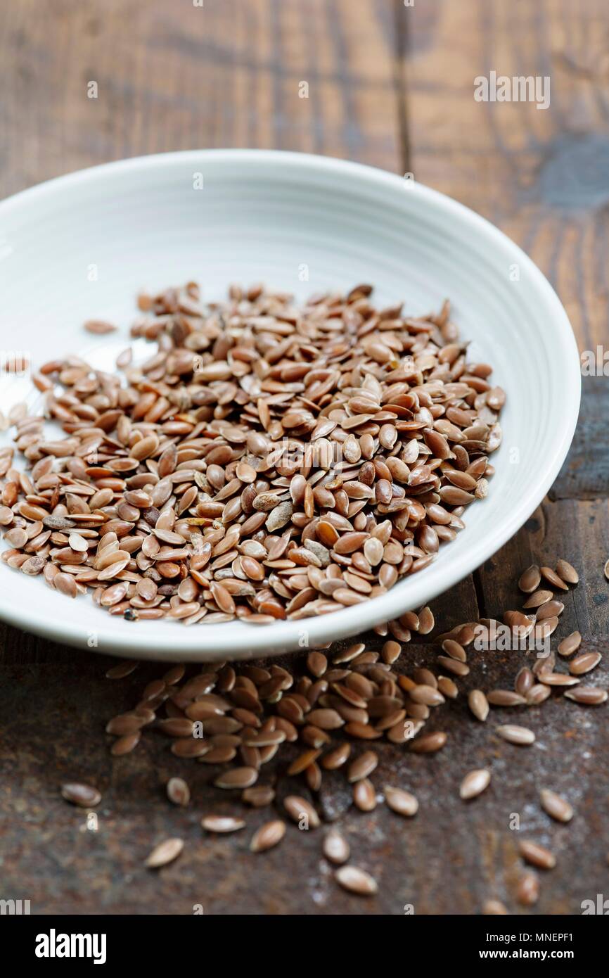 A bowl of brown flax seeds Stock Photo