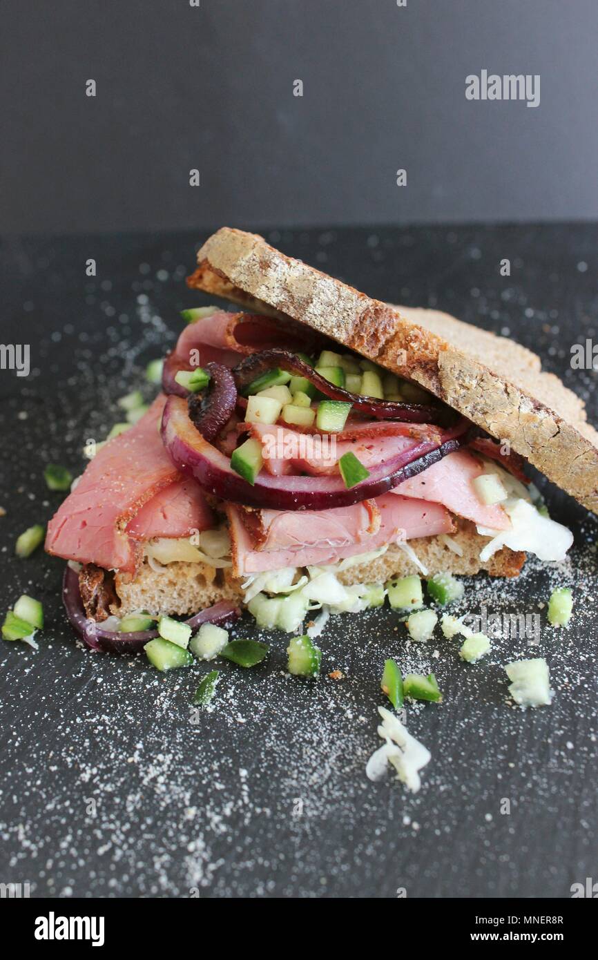 A pastrami sandwich with pieces of cucumber Stock Photo