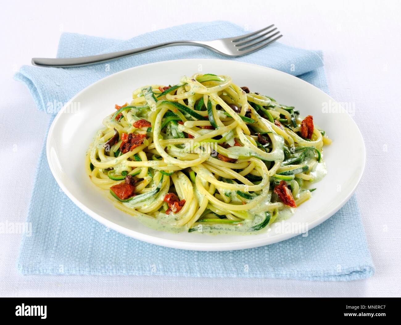 Spaghetti with courgette and olives Stock Photo