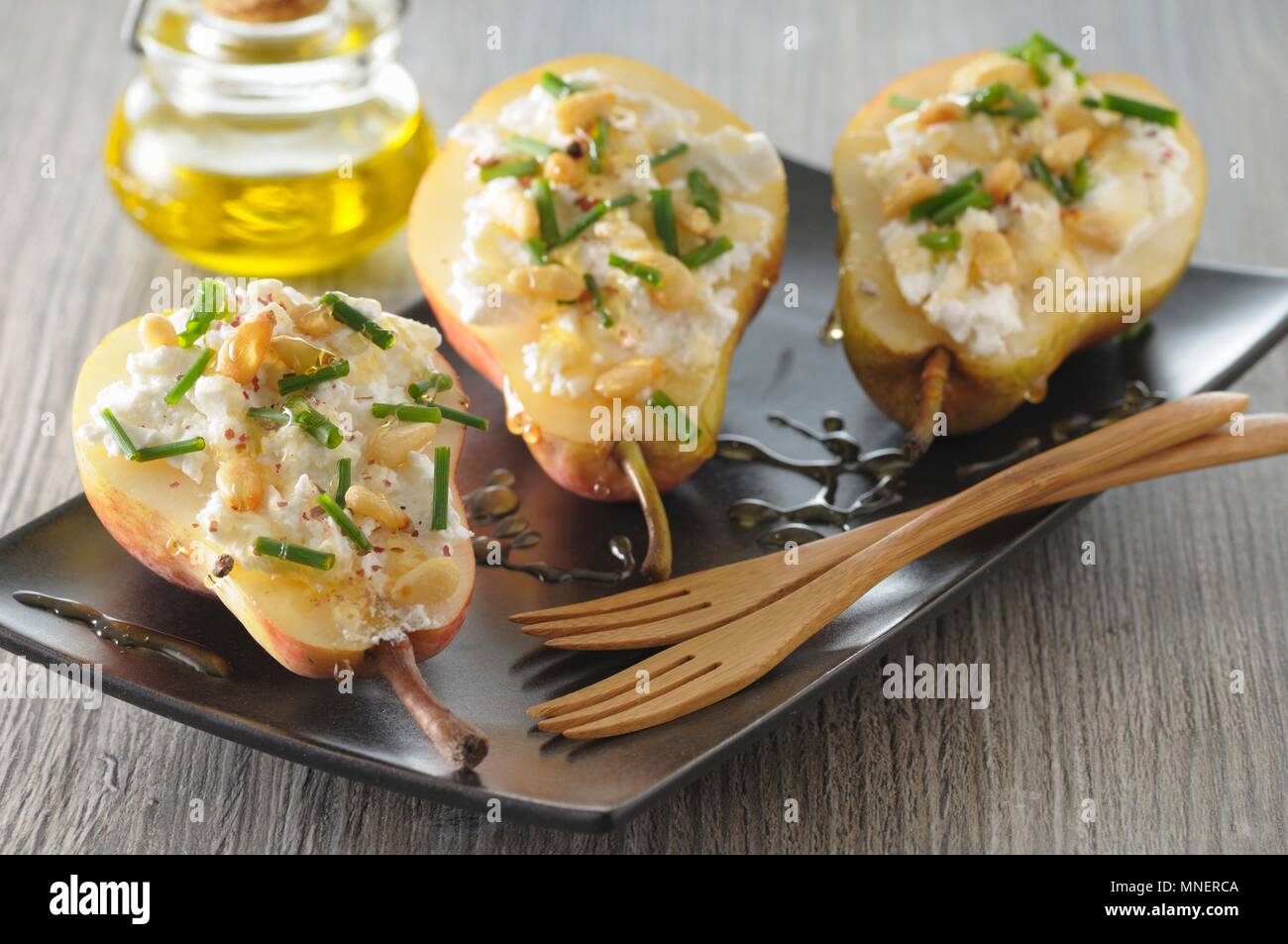 Stuff pears with goat's cheese and pine nuts Stock Photo