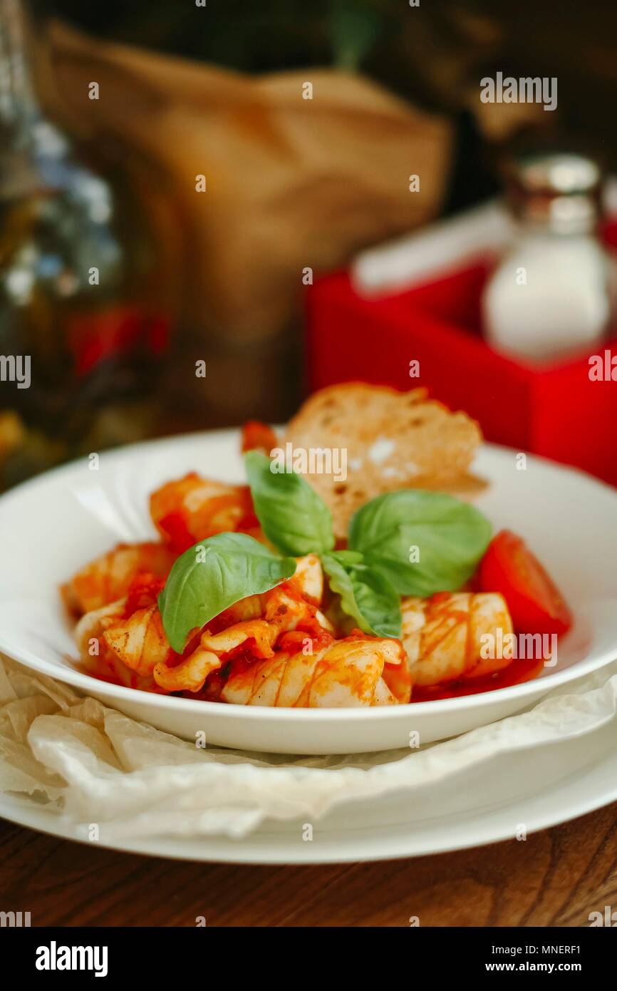 Tomato soup with seafood, basil and bread Stock Photo