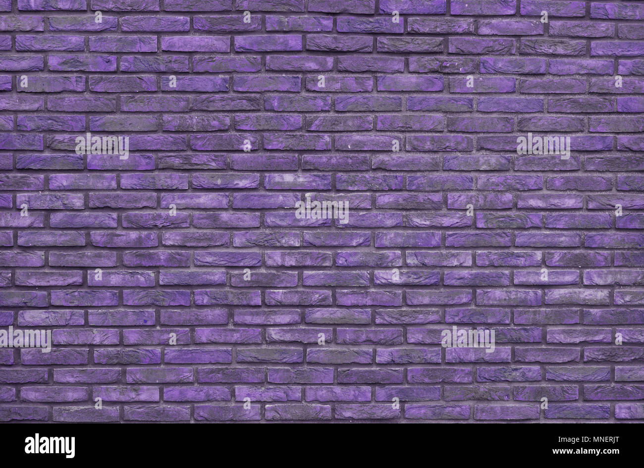 Purple brick wall background, wallpaper. Purple bricks pattern, texture. Stock Photo