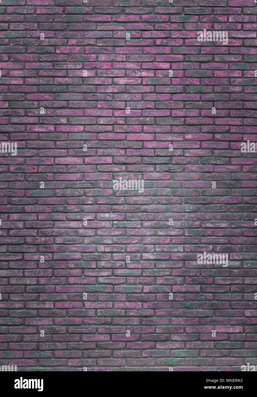 Vertical purple brick wall background, wallpaper. Purple bricks pattern, texture Stock Photo