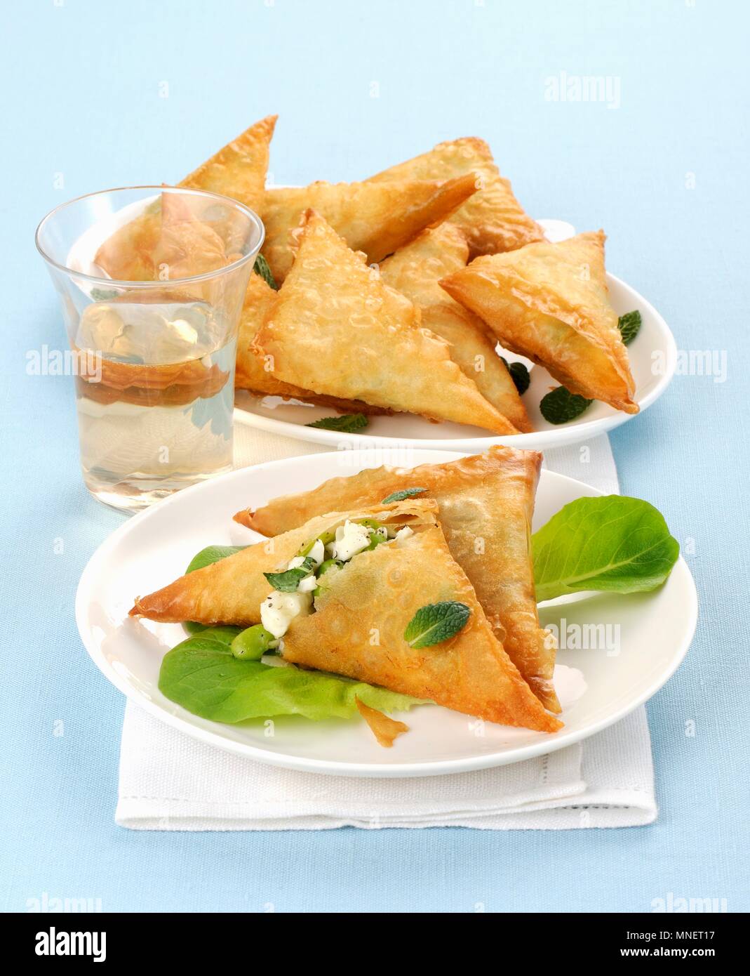 Filo pastry triangles filled with feta cheese and broad beans Stock