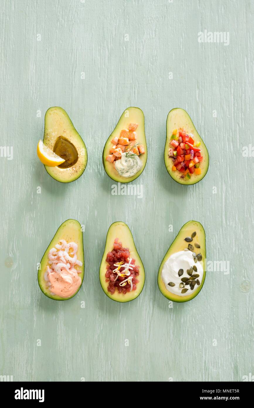 Avocados with various fillings Stock Photo