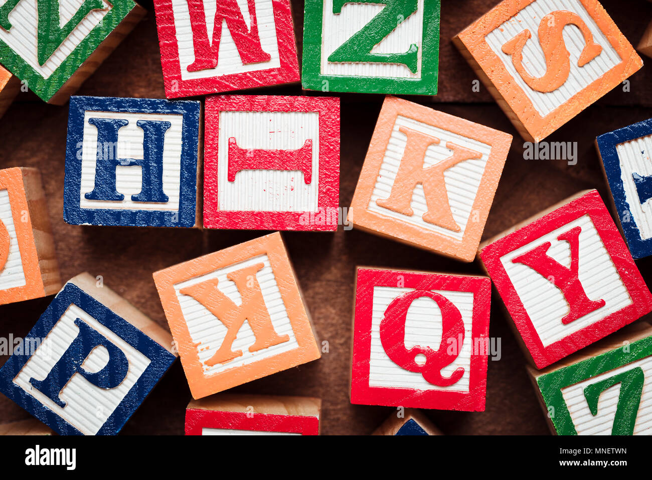 Colorful wooden letter blocks making the on brown wood background Stock Photo