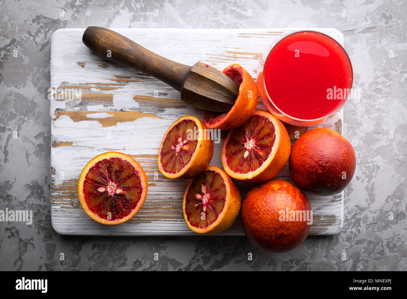 Red sicilian orange pieces on wooden board closeup Stock Photo
