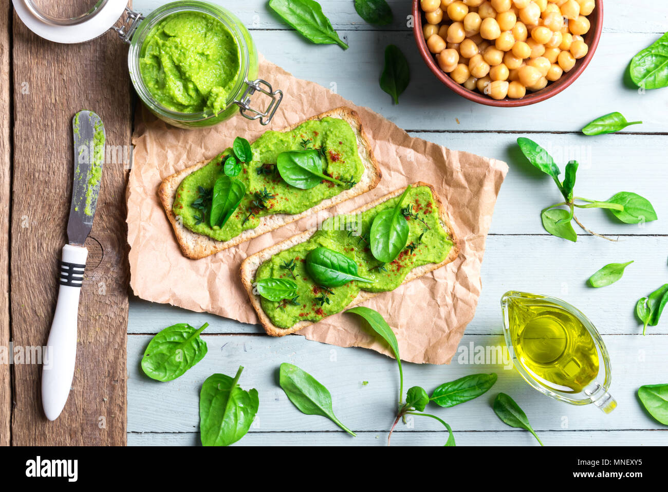 Two crackers with green spinach humus Stock Photo