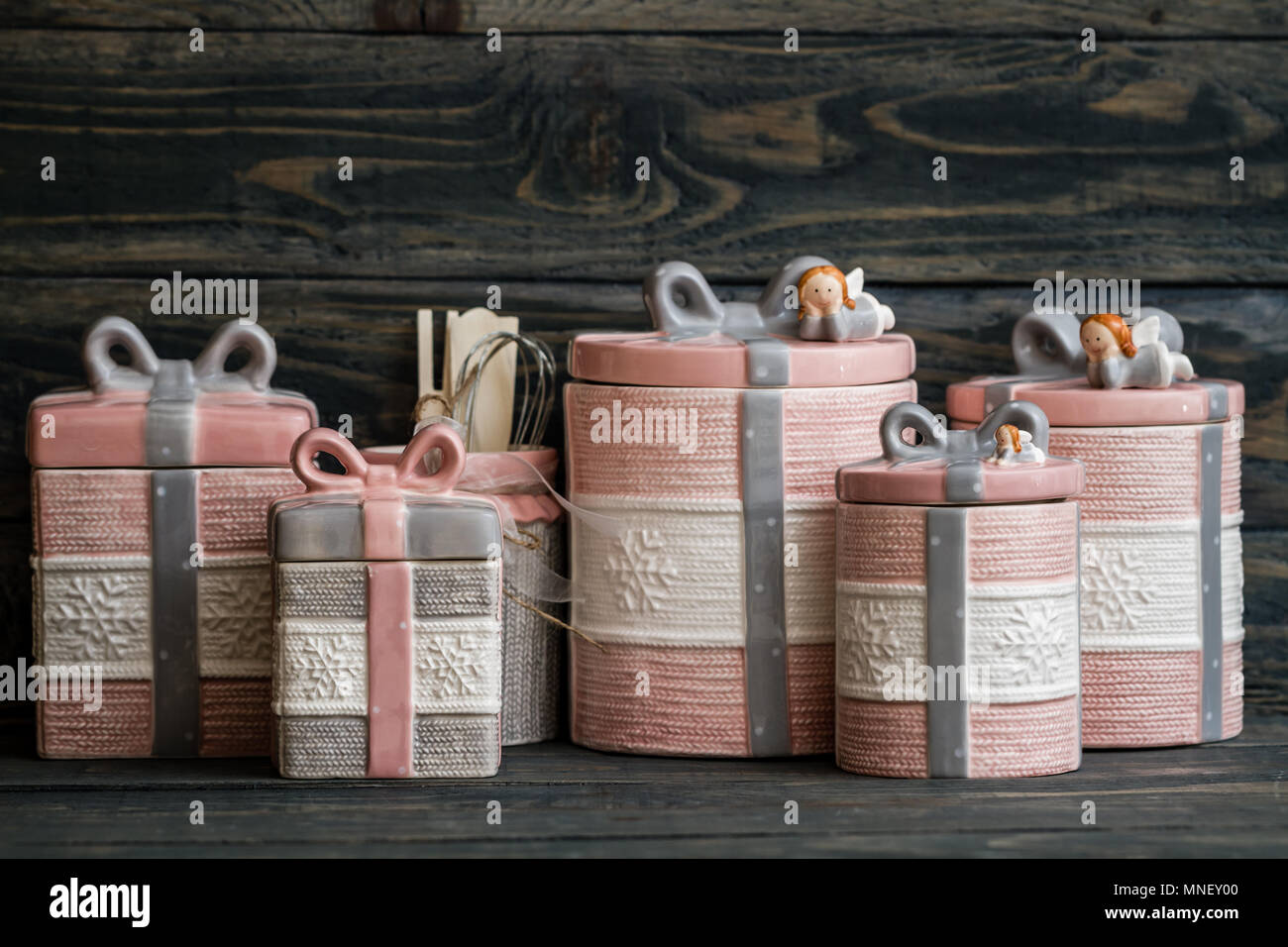 Pink, gray ceramic jars set on blue background Stock Photo