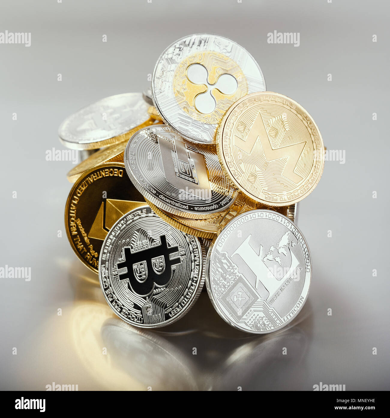 Heap of crypto coins Dash Ripple Monero Litecoin Bitcoin Ethereum on  glowing chromatic background with translucent reflection, square format  Stock Photo - Alamy