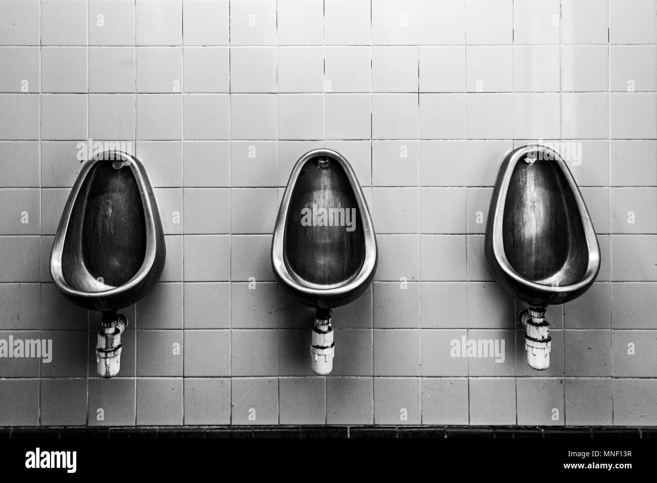 3 Stainless Steel Urinals in the Gents Toilet Stock Photo Alamy