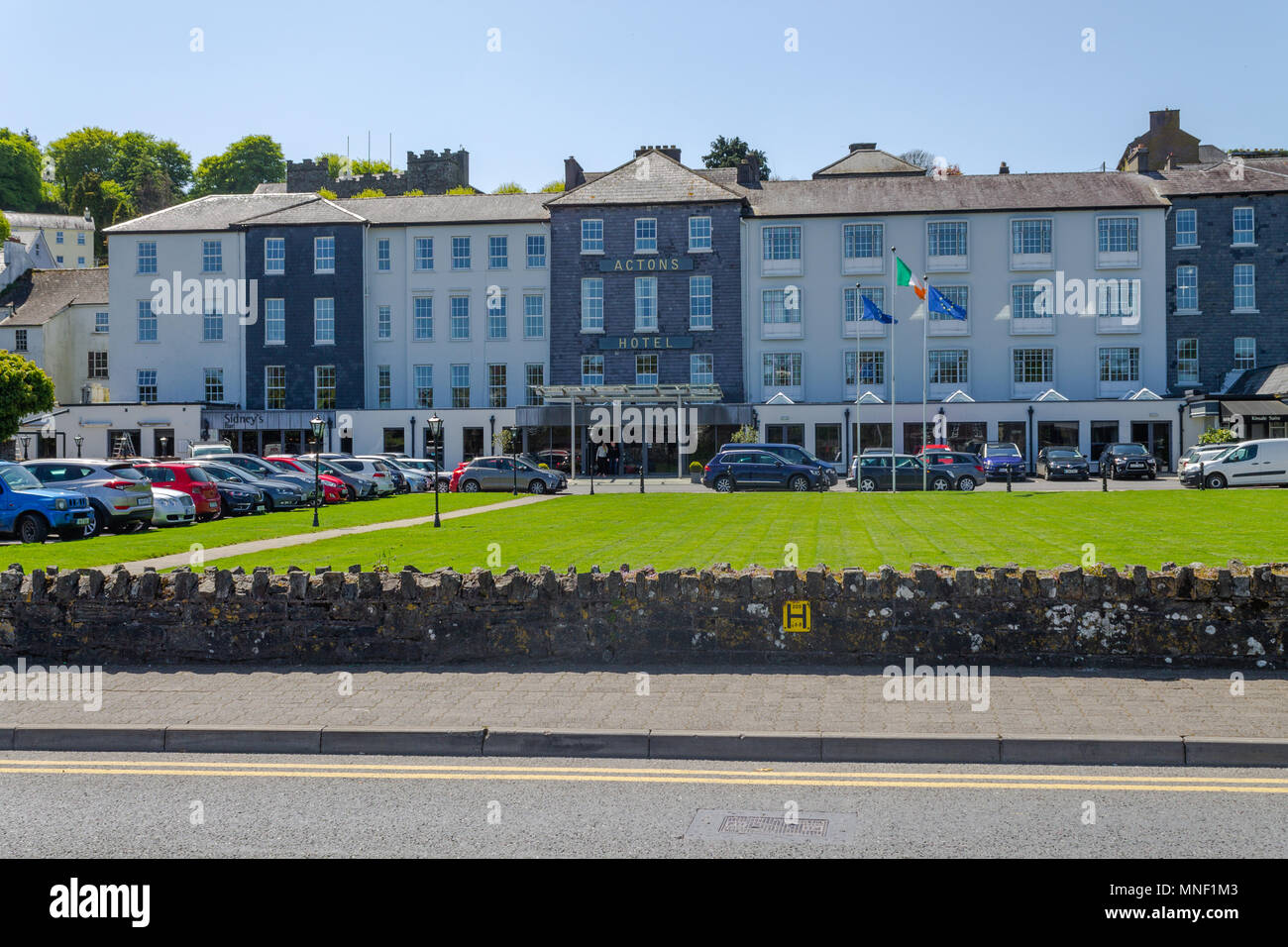 Actons hotel in kinsale ireland, with a full carpark and flags flying in the summer breeze. Kinsale is a popular seaside holiday resort town. Stock Photo