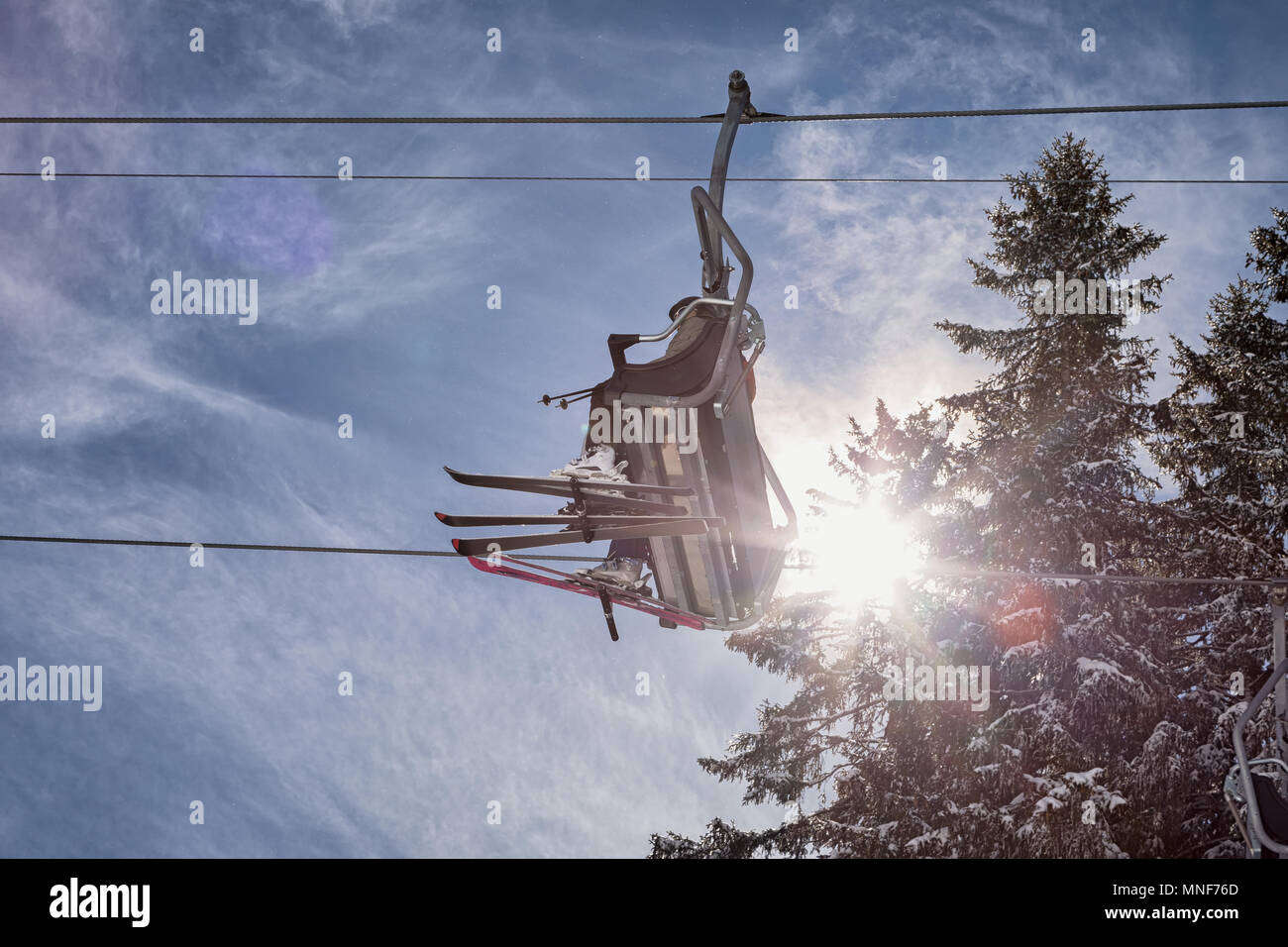 Skier in a chairlift Stock Photo