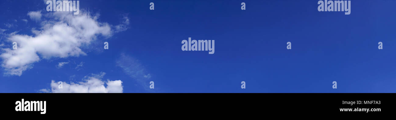 Blue sky panorama background with some white clouds Stock Photo - Alamy