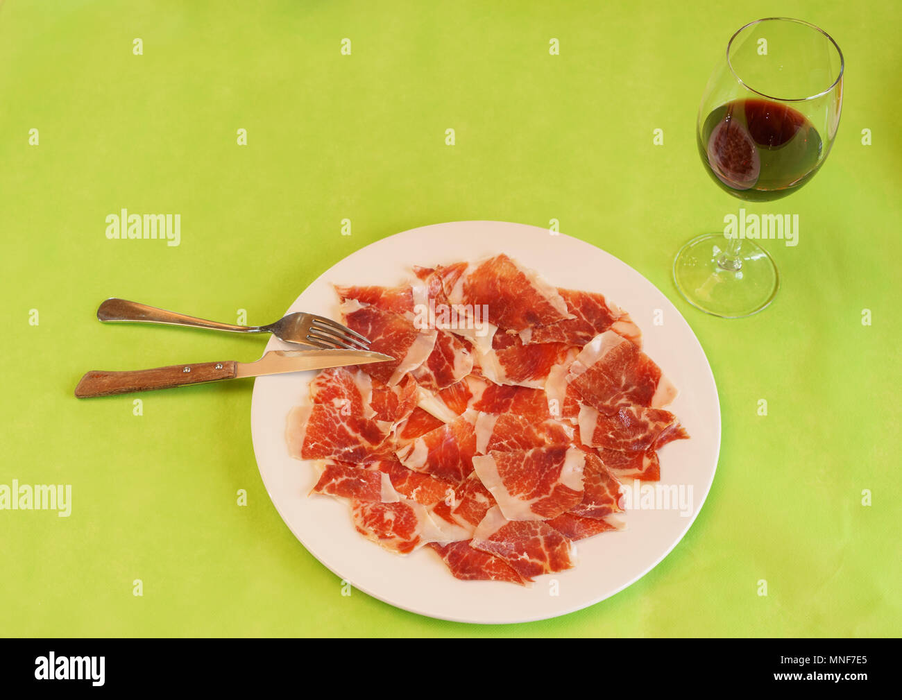 drycured ham slices on plate with wine in restaurant Stock Photo Alamy