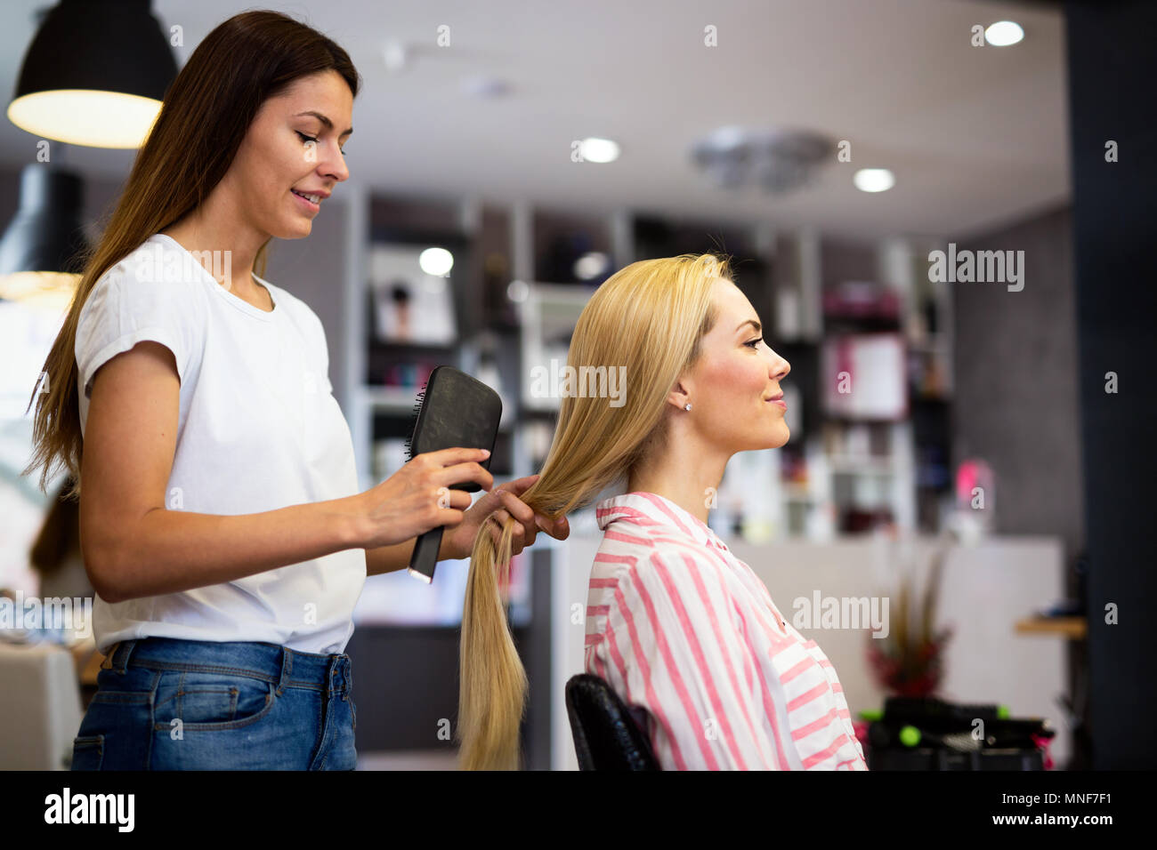 Happy woman at the hair salon Stock Photo Alamy