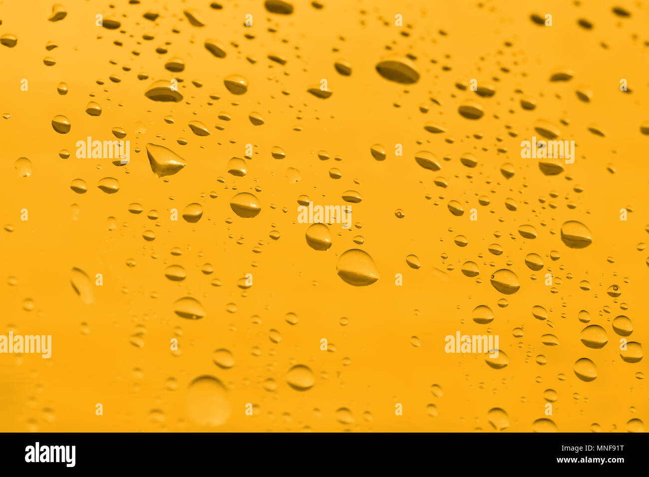water drops on a yellow background Stock Photo - Alamy