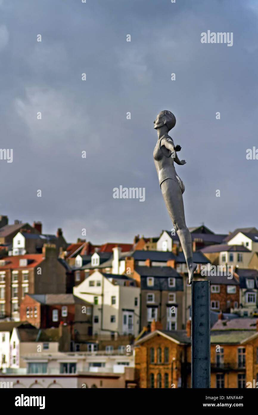 Scarborough’s Diving Belle statue stands out against the crowded backdrop of the town’s Bland’s Cliff. Stock Photo