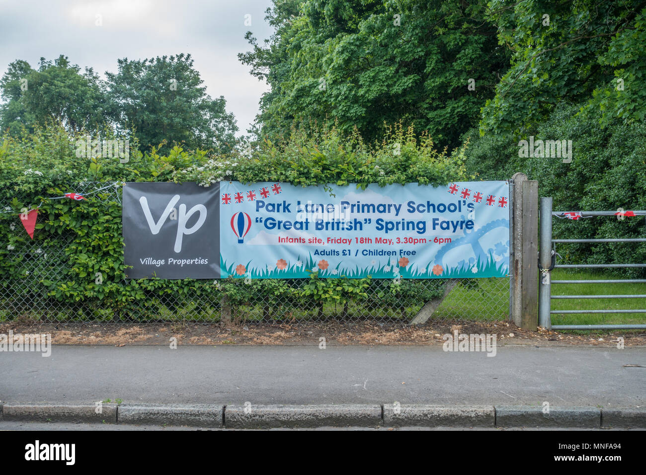 A banner on a fence advertising Park Lane primary School's spring Fayre in Tilehurst, Reading, UK Stock Photo