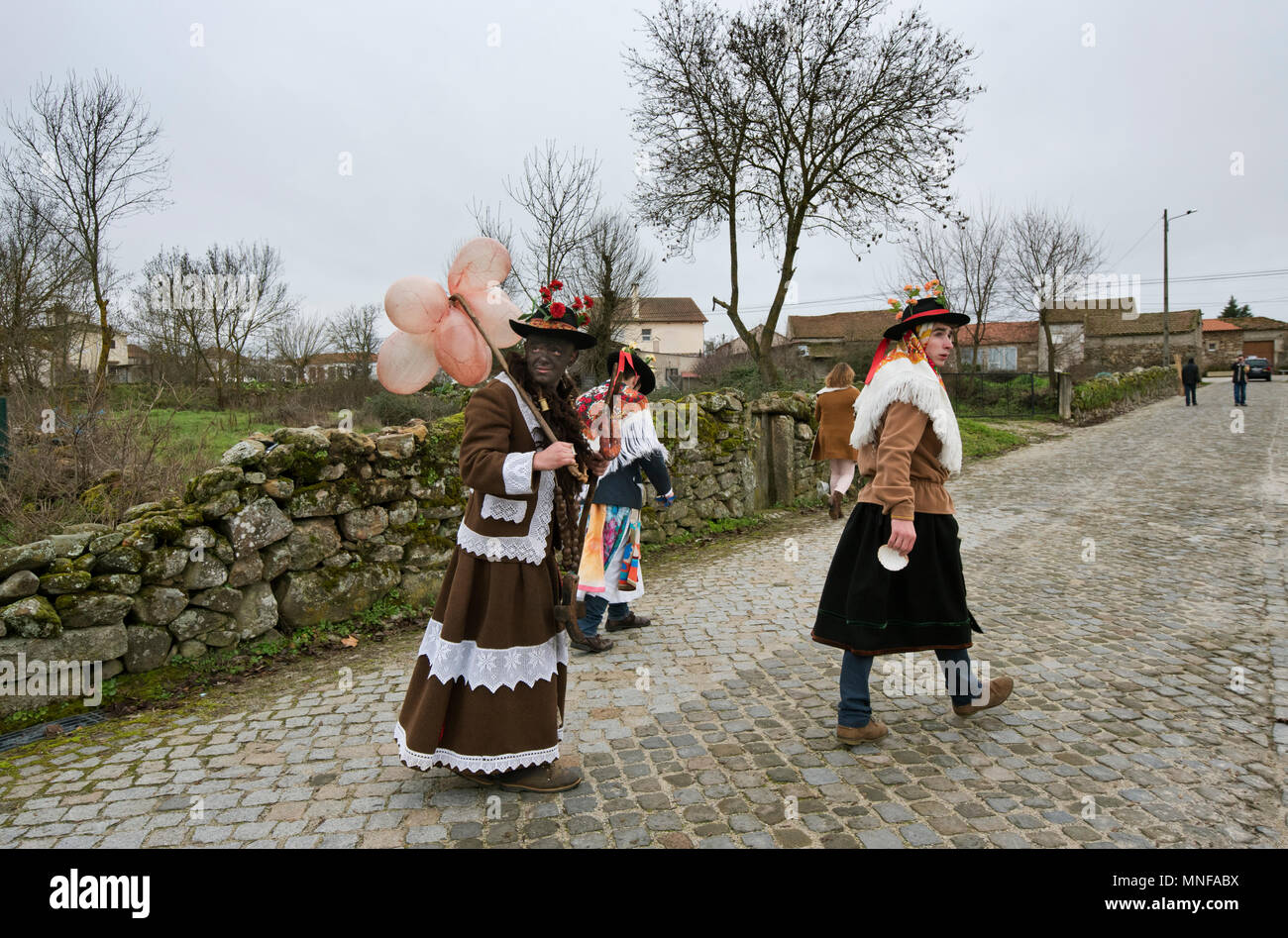 The three main characters of the Winter Solstice Festivities at Vila Cha de Braciosa go to the village to ask for offerings for the Communal Supper. T Stock Photo
