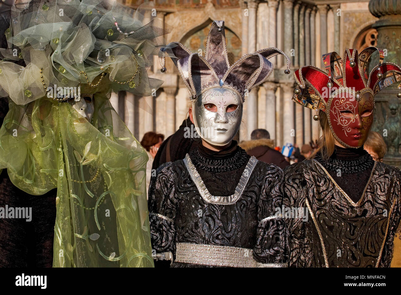 Piazza San Marco, Venice, Italy: maskers pose in front of the Basilica di San Marco Stock Photo