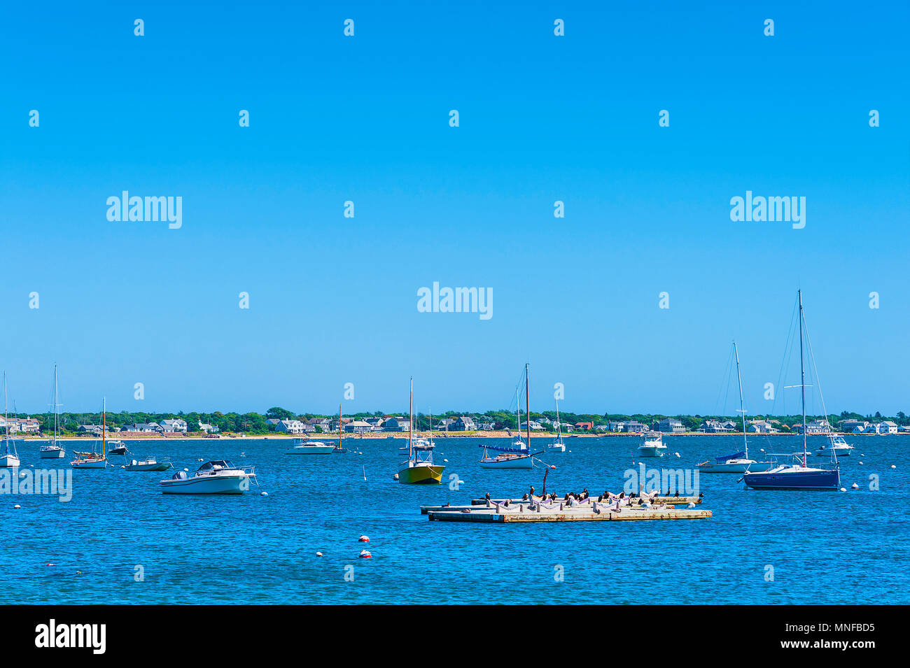 Hyannis Port, Massachusetts, USA - September 13, 2016:  Anchored boats of various sizes and shapes float in the harbor of Hyannis Port, on Cape Cod in Stock Photo