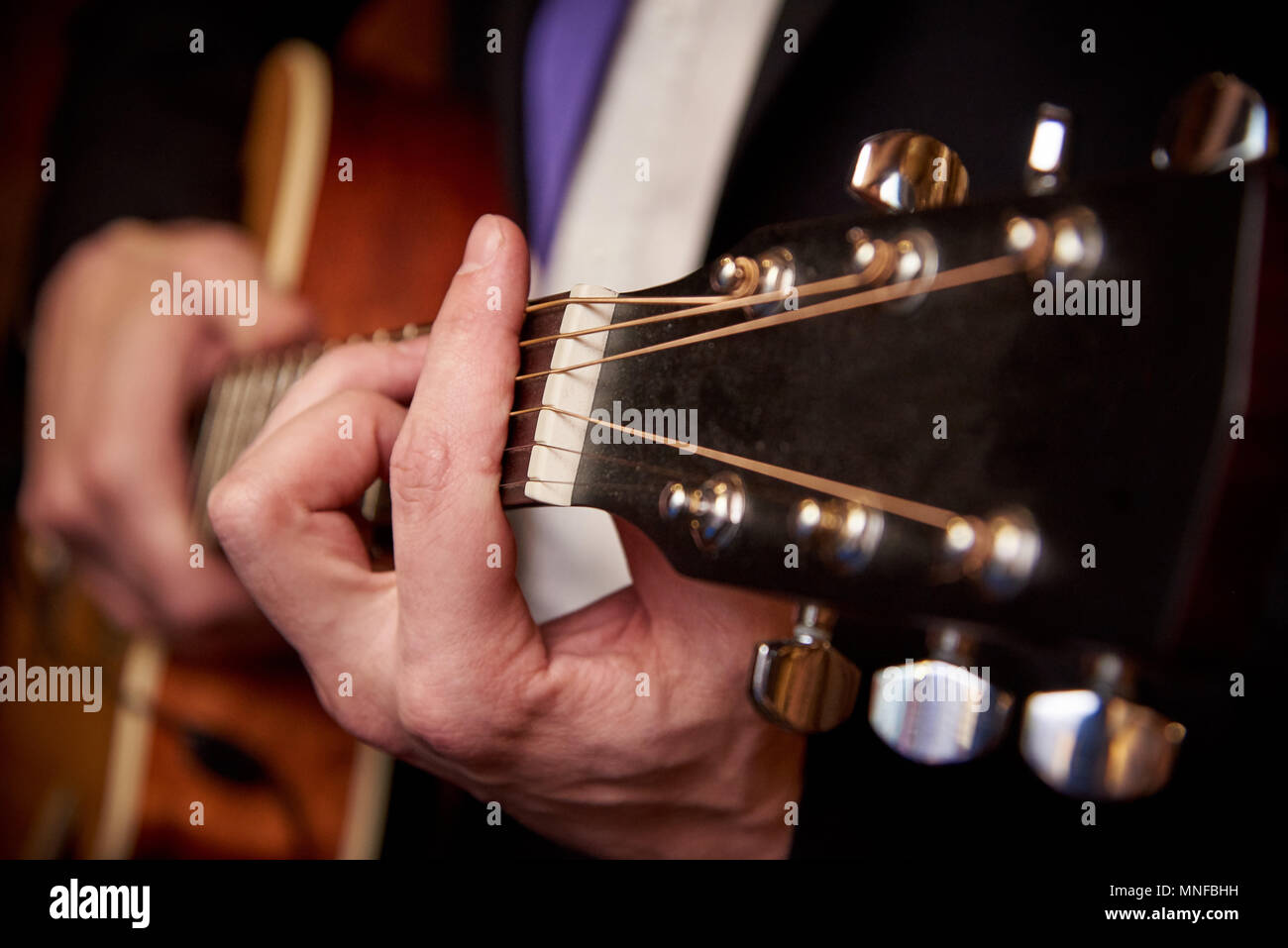 Men's hands play the guitar Stock Photo