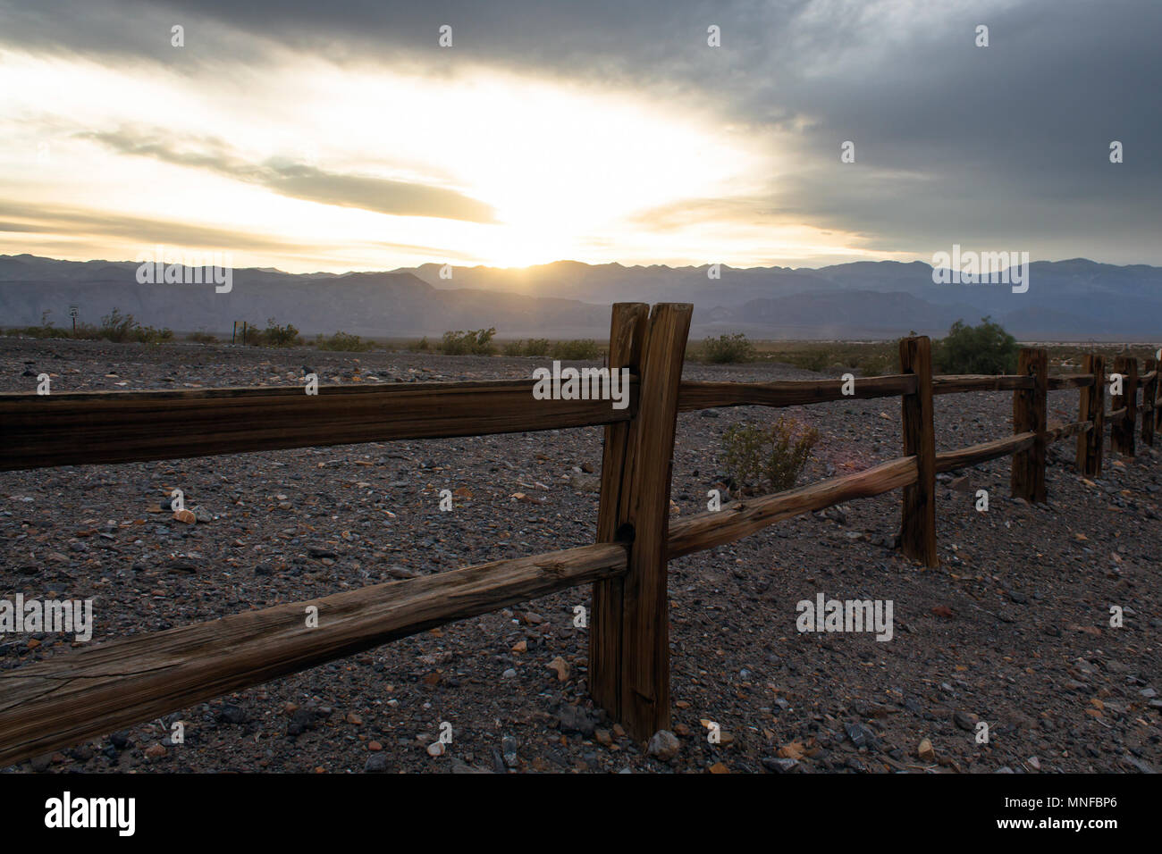 Wooden Fence in Death Valley with Setting Sun Stock Photo - Alamy