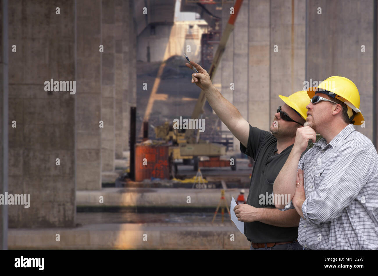 Construction engineer and foreman on a bridge building job site Stock