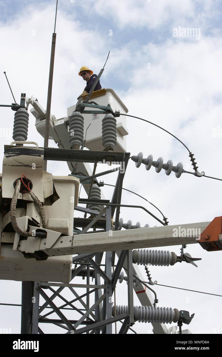 Utility company line man working from a bucket lift to repair and