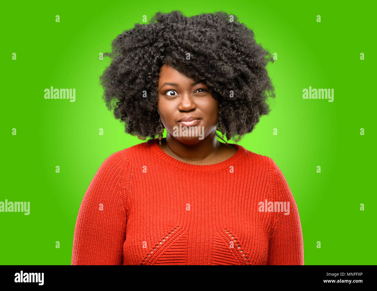 Beautiful african woman making funny face fooling Stock Photo - Alamy